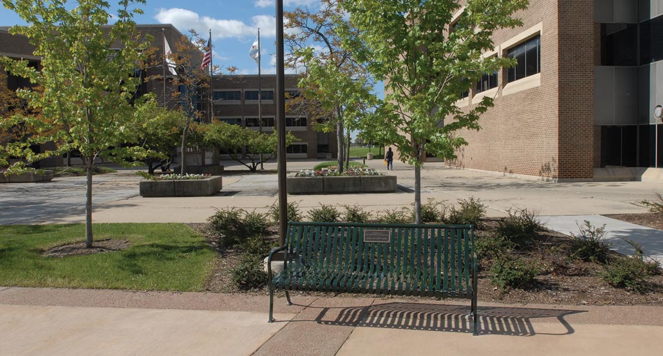 Pullman Bench with Back and Plaque installed on a University campus