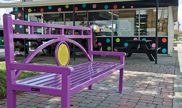 Conservatory bench with Pok A Dot circular plaque