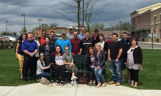 Keystone Ridge Designs employees having fun next to site furniture