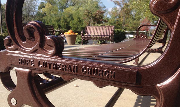 Lamplighter Bench with cast nameplates and pumpkins in the background