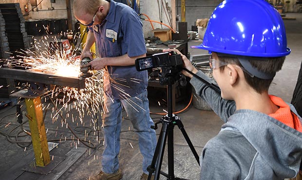 Student observing steel grinding