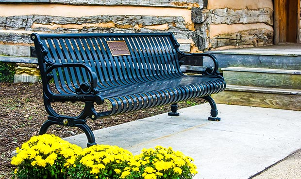 A single Lamplighter Bench on a quiet main street