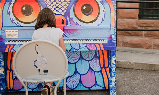 Practicing piano outdoors for a change on an Olivia Chair