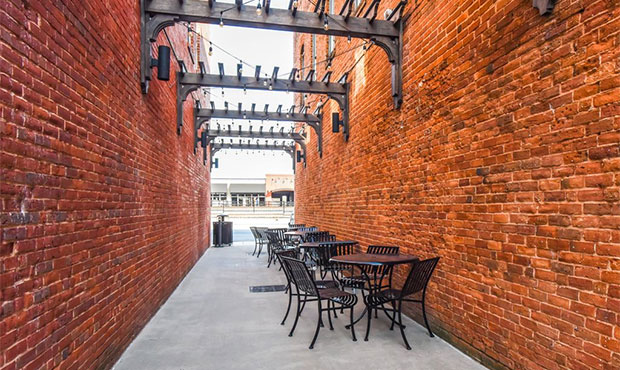 Round Courtyard Table Sets artfully arranged in a pedestrian walkway