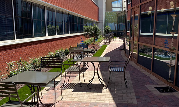 Sienna Table Sets in a small and cozy courtyard setting