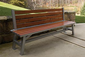 Wood Grain Aluminum Slats on Breakwater Bench with Back in front of stone wall