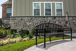 Curved McConnell Bench with Back outside an apartment complex