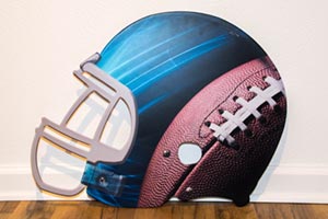 Steel football helmet shaped panel with artwork