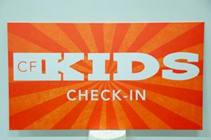 Kids Check In steel sign with artwork