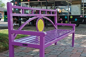 Conservatory bench with custom circular yellow plaque