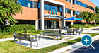 Exeter Benches flank the entrance to a corporate office building