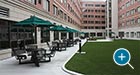 Hapsburg Table Sets with umbrellas in the courtyard of an office building