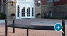 A curved Reading Flat Bench with a custom radius outside a school building