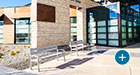 A pair of Everett benches stationed outside an educational facility