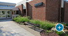 A Pullman Flat Bench sits outside a campus Athletic Center