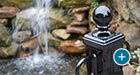 Close up of a Bellevue Bollard with two chain loops in front of a waterfall