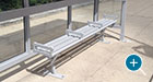 This Penn Flat Bench has been customized with dividing arms at a bus shelter