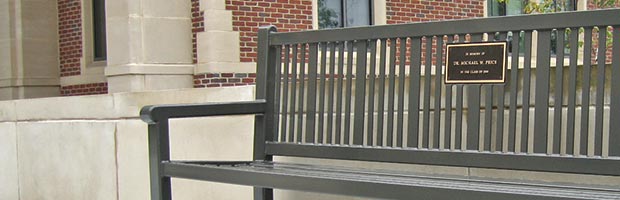Reading bench with plaque on college campus